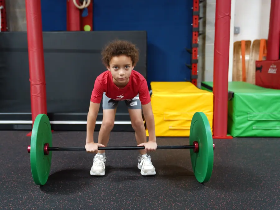 Young athlete practicing a barbell lift at Vortex