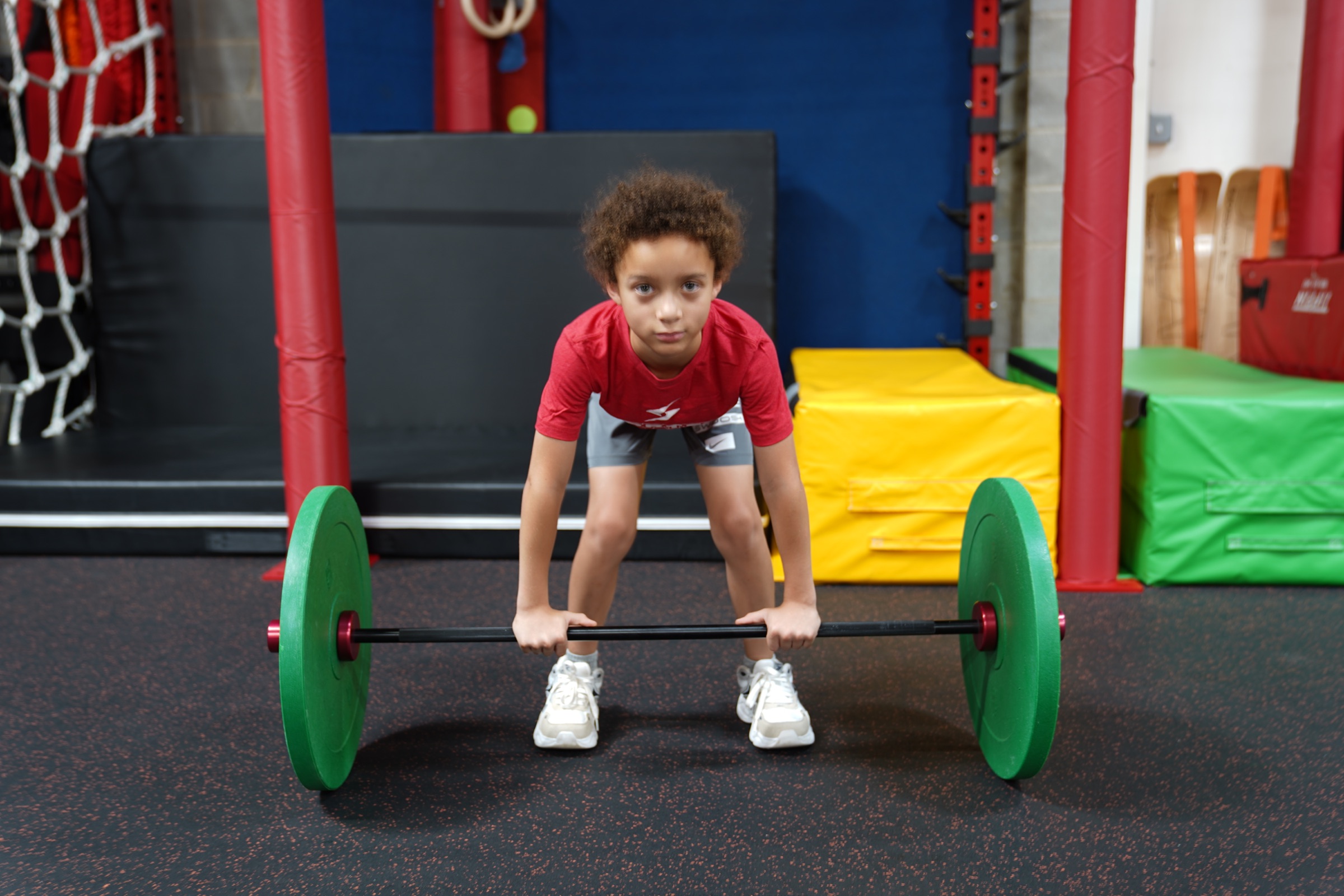 Young athlete practicing a barbell lift at Vortex